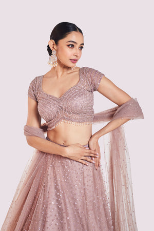 Buy beautiful onion pink embroidered net lehenga online in USA with dupatta. Shop the best and latest designs in embroidered sarees, designer sarees, Anarkali suit, lehengas, sharara suits for weddings and special occasions from Pure Elegance Indian fashion store in USA.-closeup