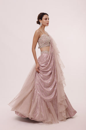 Shop the look your best on wedding occasions in this old rose pink silver sequinned lehenga with a sleeveless cut dana work, heavy embroidered blouse & dupatta. Dazzle on weddings and special occasions with exquisite Indian designer dresses, sharara suits, Anarkali suits, bridal lehengas, and sharara suits from Pure Elegance Indian clothing store in the USA. Shop online from Pure Elegance.