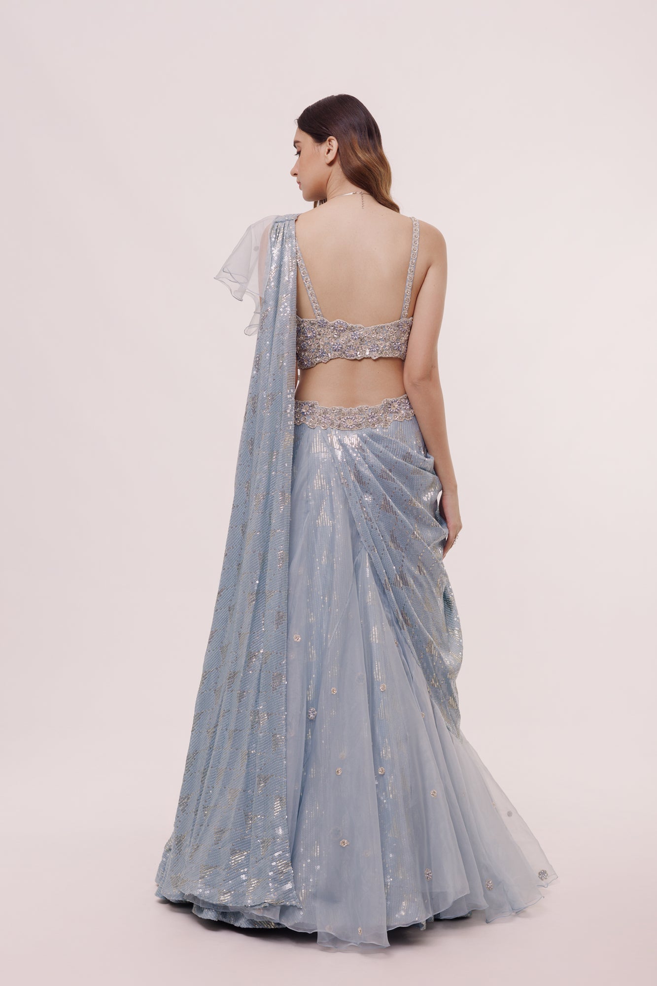Shop the Look your best on wedding occasions in this pastel blue lehenga with sequin, cut dana work, and ruffle dupatta. Dazzle on weddings and special occasions with exquisite Indian designer dresses, sharara suits, Anarkali suits, bridal lehengas, and sharara suits from Pure Elegance Indian clothing store in the USA. Shop online from Pure Elegance.