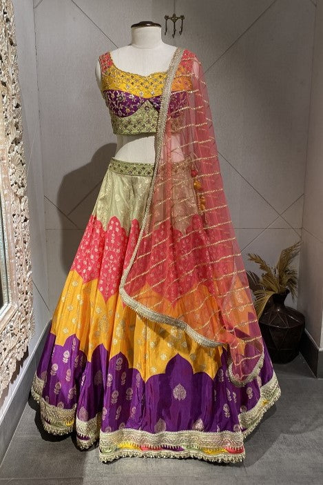 Buy a Beautiful multicolor lehenga with a dupatta. The lehenga is perfect for mehandi and sangeet parties. It is crafted in silk with metallic 3D work. Shop online from Pure Elegance.