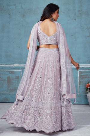 Buy lilac heavy embroidery georgette lehenga online in USA with dupatta. Look royal on special occasions in exquisite designer lehengas, pure silk sarees, handloom sarees, Bollywood sarees, Anarkali suits, Banarasi sarees, organza sarees from Pure Elegance Indian saree store in USA.-back