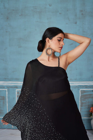 Shop stunning black embroidered crepe silk top online in USA with skirt. Look royal on special occasions in exquisite designer lehengas, pure silk sarees, handloom sarees, Bollywood sarees, Anarkali suits, Banarasi sarees, organza sarees from Pure Elegance Indian saree store in USA.-closeup