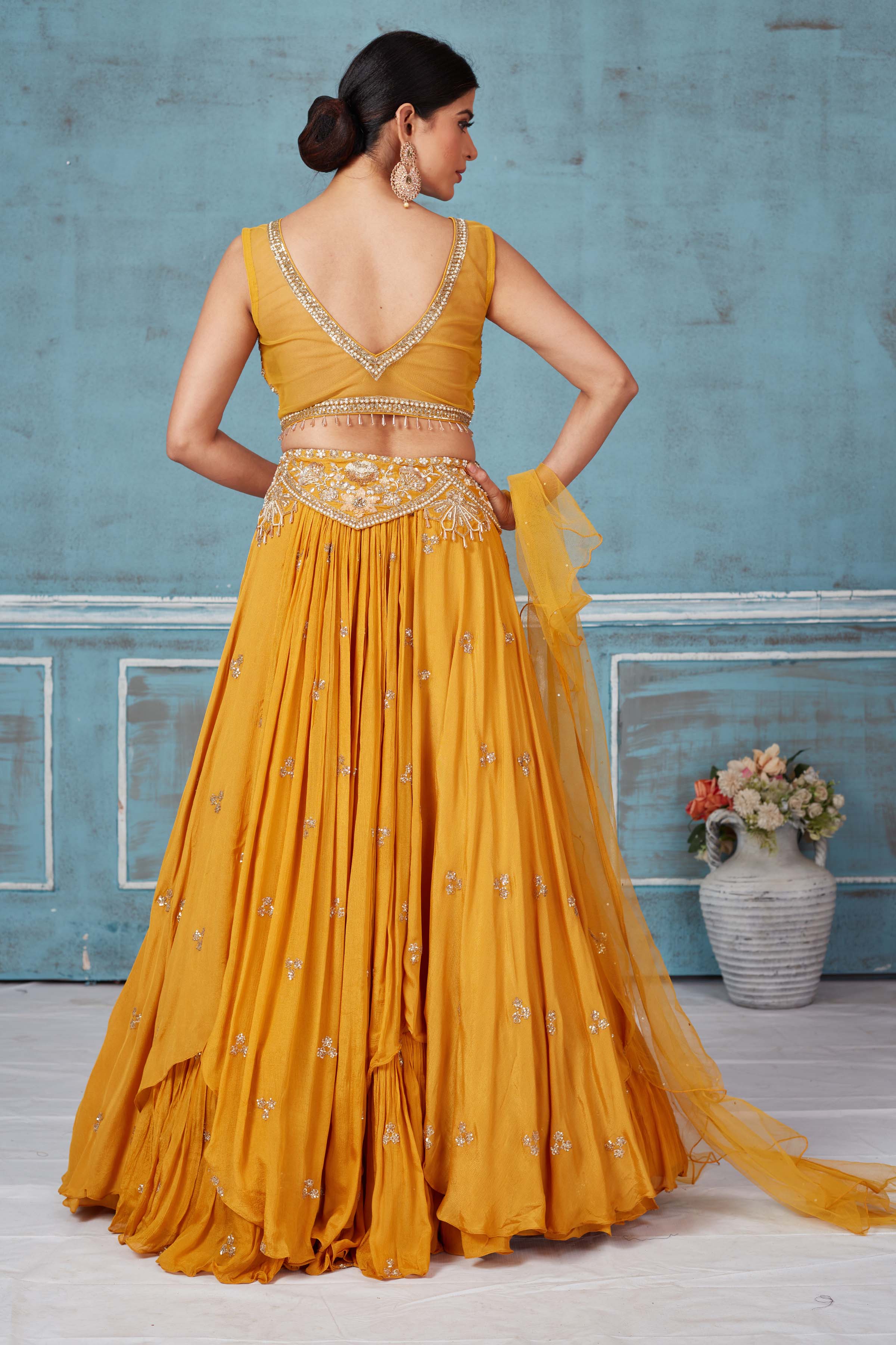 Shop beautiful mustard hand embroidered georgette lehenga online in USA with dupatta. Look royal on special occasions in exquisite designer lehengas, pure silk sarees, handloom sarees, Bollywood sarees, Anarkali suits, Banarasi sarees, organza sarees from Pure Elegance Indian saree store in USA.-back