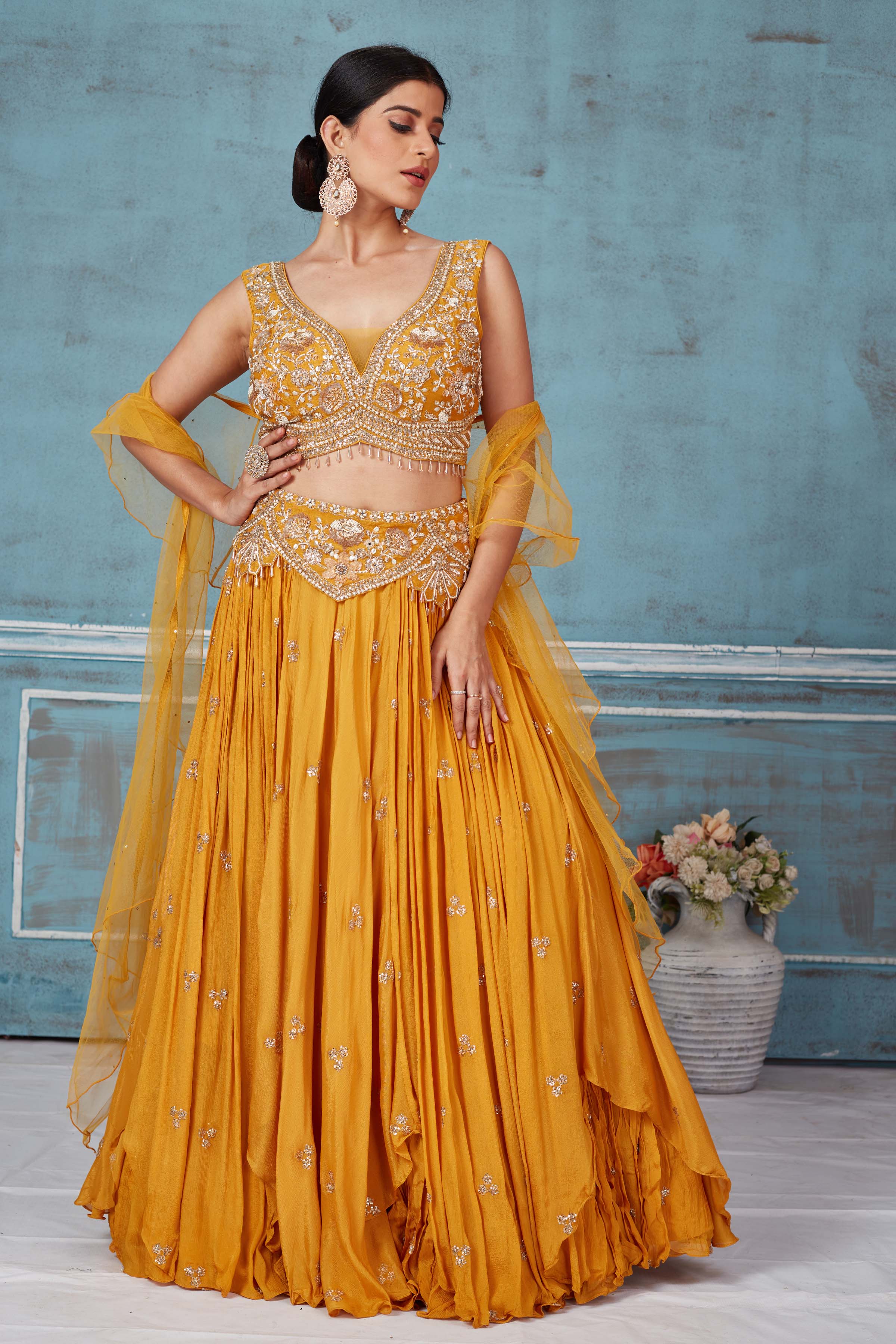 Shop beautiful mustard hand embroidered georgette lehenga online in USA with dupatta. Look royal on special occasions in exquisite designer lehengas, pure silk sarees, handloom sarees, Bollywood sarees, Anarkali suits, Banarasi sarees, organza sarees from Pure Elegance Indian saree store in USA.-front