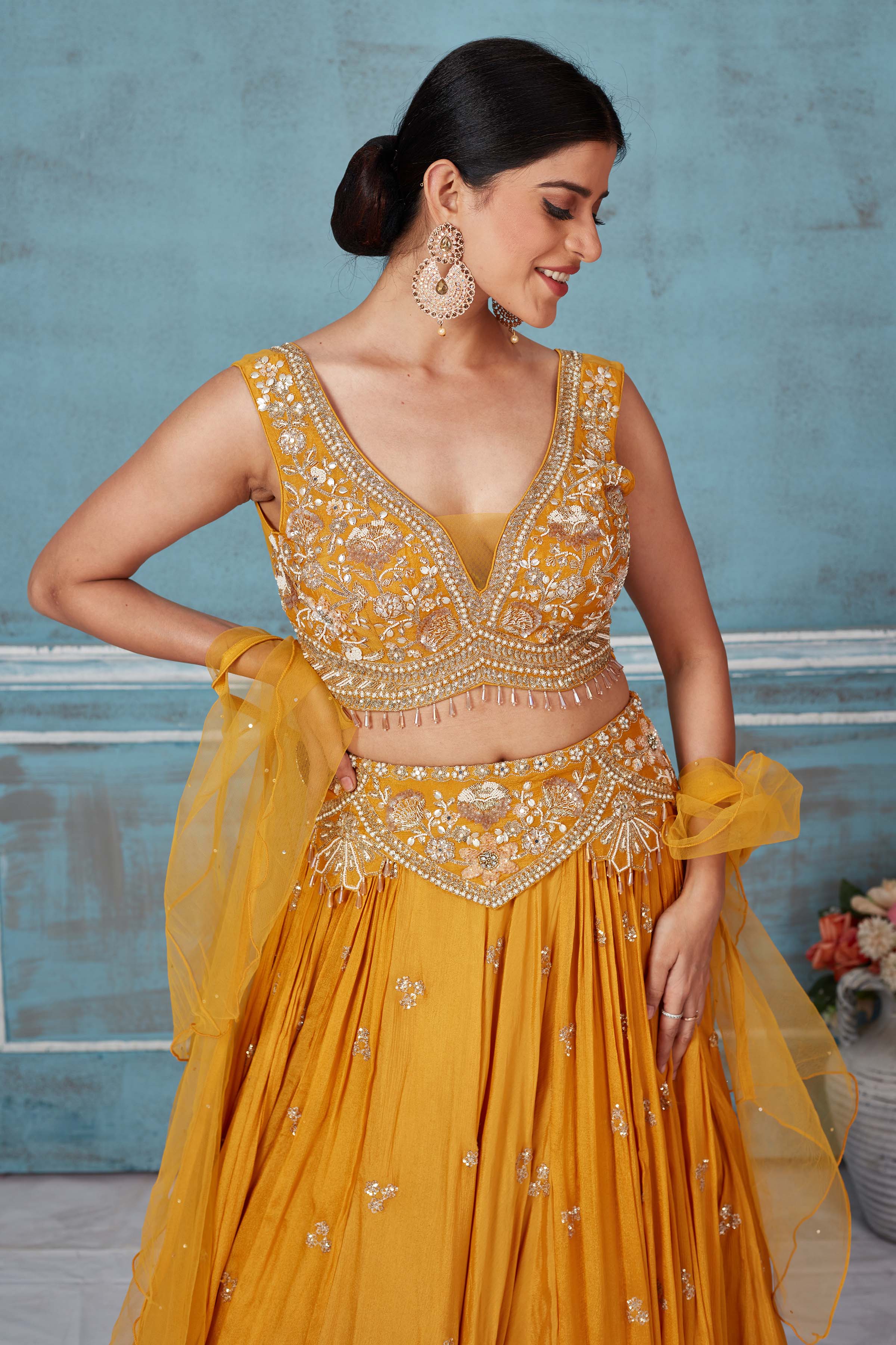 Shop beautiful mustard hand embroidered georgette lehenga online in USA with dupatta. Look royal on special occasions in exquisite designer lehengas, pure silk sarees, handloom sarees, Bollywood sarees, Anarkali suits, Banarasi sarees, organza sarees from Pure Elegance Indian saree store in USA.-closeup