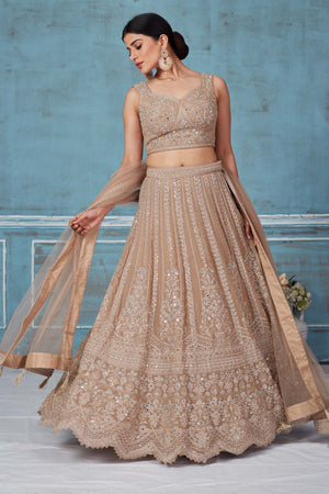 Buy beige embroidered designer lehenga online in USA with dupatta. Look royal on special occasions in exquisite designer lehengas, pure silk sarees, handloom sarees, Bollywood sarees, Anarkali suits, Banarasi sarees, organza sarees from Pure Elegance Indian saree store in USA.-front