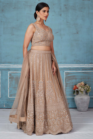 Buy beige embroidered designer lehenga online in USA with dupatta. Look royal on special occasions in exquisite designer lehengas, pure silk sarees, handloom sarees, Bollywood sarees, Anarkali suits, Banarasi sarees, organza sarees from Pure Elegance Indian saree store in USA.-lehenga