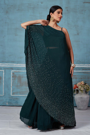 Shop dark green one shoulder georgette dress online in USA. Look royal on special occasions in exquisite designer lehengas, pure silk sarees, handloom sarees, Bollywood sarees, Anarkali suits, Banarasi sarees, organza sarees from Pure Elegance Indian saree store in USA.-dress