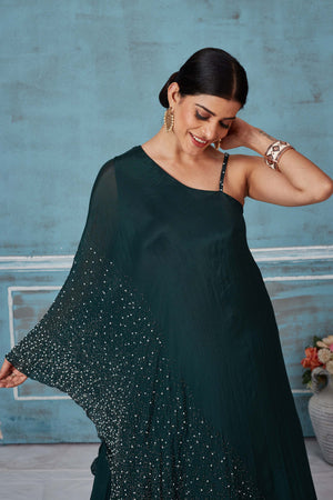 Shop dark green one shoulder georgette dress online in USA. Look royal on special occasions in exquisite designer lehengas, pure silk sarees, handloom sarees, Bollywood sarees, Anarkali suits, Banarasi sarees, organza sarees from Pure Elegance Indian saree store in USA.-closeup