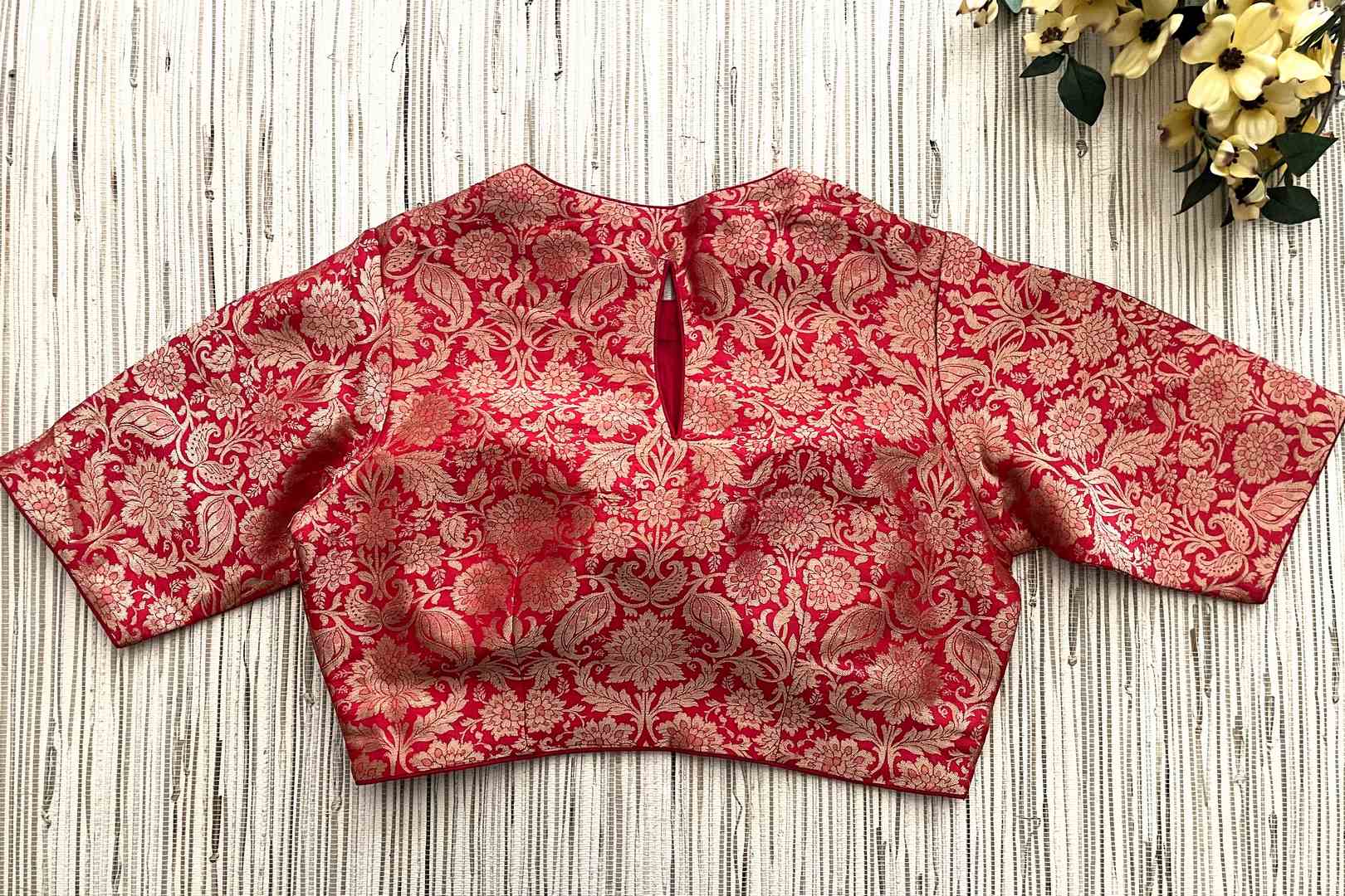 Shop red Banarasi saree blouse online in USA with elbow sleeves. Elevate your saree style with exquisite readymade sari blouses, embroidered saree blouses, Banarasi sari blouse, designer saree blouse, choli-cut blouses, corset blouses from Pure Elegance Indian fashion store in USA.-back