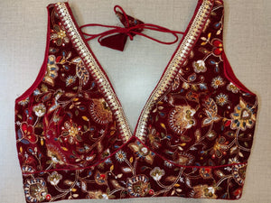 Shop beautiful maroon heavy embroidery velvet sleeveless saree blouse online in USA. Elevate your Indian saree style with exquisite readymade sari blouse, embroidered saree blouses, Banarasi saree blouse, designer sari blouse, choli-cut blouses from Pure Elegance Indian clothing store in USA.-full view