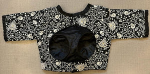 Buy black saree blouse online in USA with white floral embroidery. Elevate your saree style with exquisite readymade saree blouses, embroidered saree blouses, Banarasi sari blouse, designer sari blouse, choli-cut blouse, corset blouses from Pure Elegance Indian fashion store in USA.-back