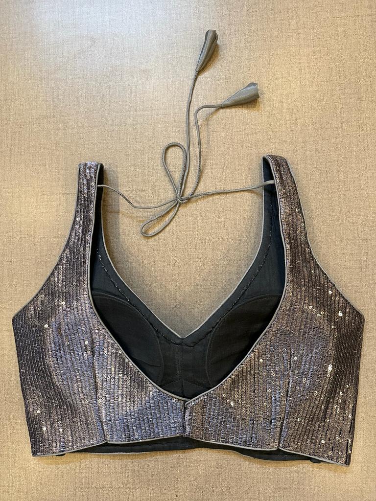 Shop grey shimmery sleeveless designer saree blouse online in USA. Elevate your saree style with exquisite readymade sari blouses, embroidered saree blouses, Banarasi sari blouse, designer saree blouse, choli-cut blouses, corset blouses from Pure Elegance Indian fashion store in USA.-back