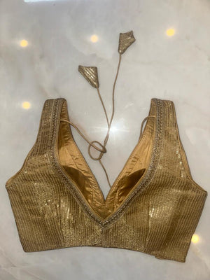 Buy golden shimmer saree blouse online in USA with sequin lace. Elevate your saree style with exquisite readymade sari blouses, embroidered saree blouses, Banarasi sari blouse, designer saree blouse, choli-cut blouses, corset blouses from Pure Elegance Indian fashion store in USA.-back