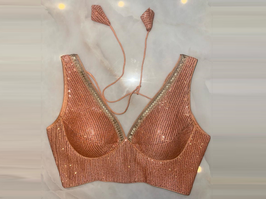 Buy peach sequin sleeveless saree blouse online in USA with golden lace. Elevate your saree style with exquisite readymade sari blouses, embroidered saree blouses, Banarasi sari blouse, designer saree blouse, choli-cut blouses, corset blouses from Pure Elegance Indian fashion store in USA.-full view