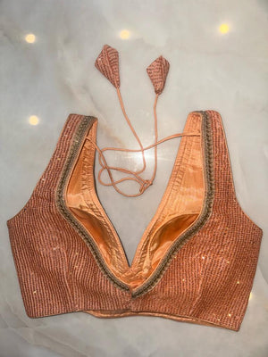 Buy peach sequin sleeveless saree blouse online in USA with golden lace. Elevate your saree style with exquisite readymade sari blouses, embroidered saree blouses, Banarasi sari blouse, designer saree blouse, choli-cut blouses, corset blouses from Pure Elegance Indian fashion store in USA.-back