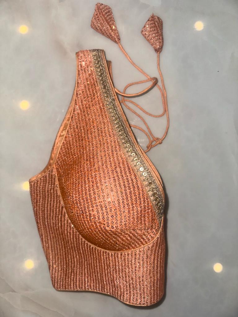 Buy peach sequin sleeveless saree blouse online in USA with golden lace. Elevate your saree style with exquisite readymade sari blouses, embroidered saree blouses, Banarasi sari blouse, designer saree blouse, choli-cut blouses, corset blouses from Pure Elegance Indian fashion store in USA.-side