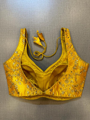 Buy yellow saree blouse online in USA with golden embroidery. Elevate your saree style with exquisite readymade sari blouses, embroidered saree blouses, Banarasi sari blouse, designer saree blouse, choli-cut blouses, corset blouses from Pure Elegance Indian fashion store in USA.-back