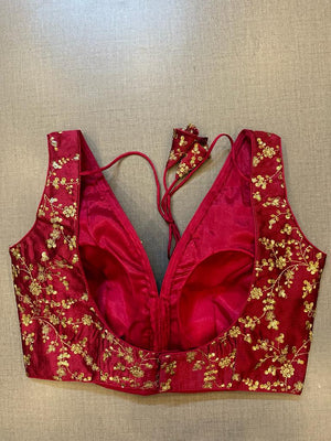 Buy maroon sleeveless saree blouse online in USA with golden embroidery. Elevate your saree style with exquisite readymade sari blouses, embroidered saree blouses, Banarasi sari blouse, designer saree blouse, choli-cut blouses, corset blouses from Pure Elegance Indian fashion store in USA.-back