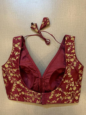 Buy dark maroon sleeveless saree blouse online in USA with golden embroidery. Elevate your saree style with exquisite readymade sari blouses, embroidered saree blouses, Banarasi sari blouse, designer saree blouse, choli-cut blouses, corset blouses from Pure Elegance Indian fashion store in USA.-back