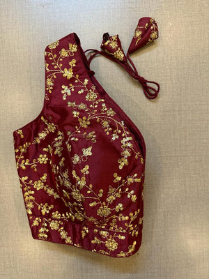 Buy dark maroon sleeveless saree blouse online in USA with golden embroidery. Elevate your saree style with exquisite readymade sari blouses, embroidered saree blouses, Banarasi sari blouse, designer saree blouse, choli-cut blouses, corset blouses from Pure Elegance Indian fashion store in USA.-side