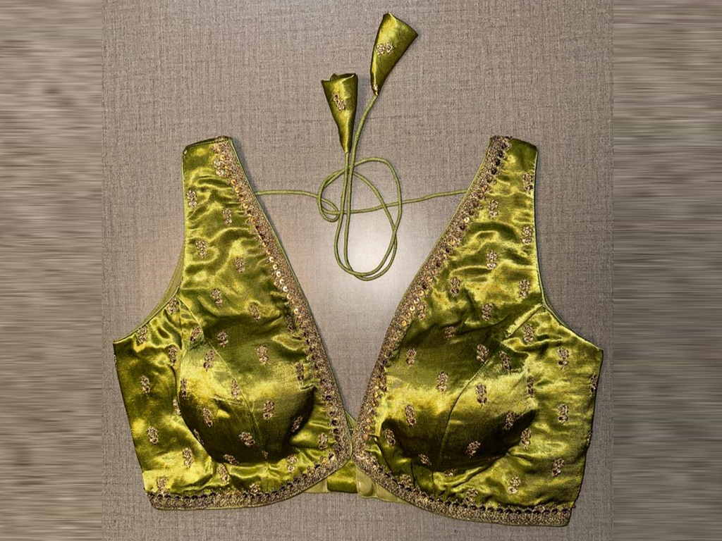 Shop green embroidered sleeveless saree blouse online in USA. Elevate your saree style with exquisite readymade sari blouses, embroidered saree blouses, Banarasi sari blouse, designer saree blouse, choli-cut blouses, corset blouses from Pure Elegance Indian fashion store in USA.-full view