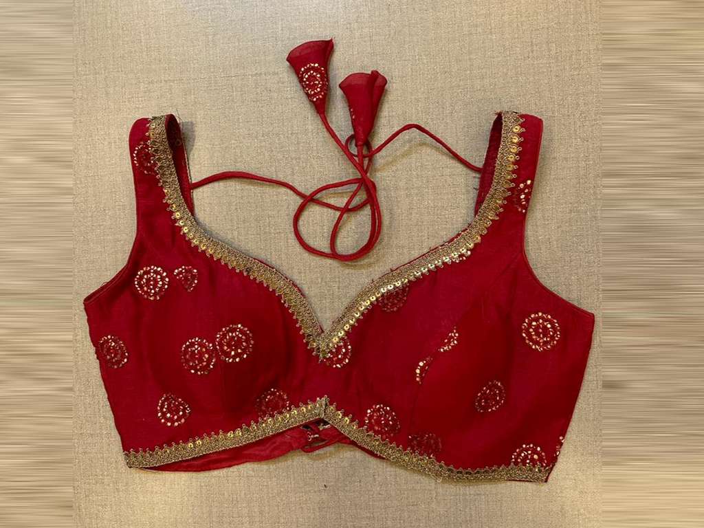 Shop red embroidered sleeveless saree blouse online in USA. Elevate your saree style with exquisite readymade sari blouses, embroidered saree blouses, Banarasi sari blouse, designer saree blouse, choli-cut blouses, corset blouses from Pure Elegance Indian fashion store in USA.-full view