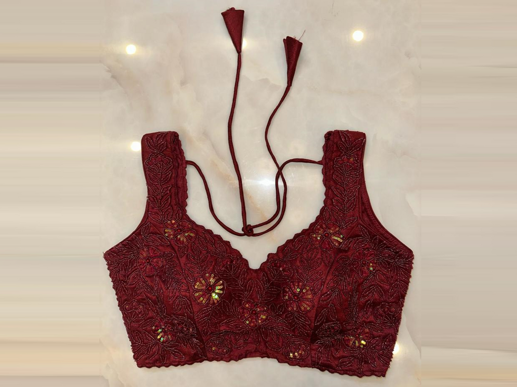 Shop maroon hand embroidered sleeveless saree blouse online in USA. Elevate your saree style with exquisite readymade sari blouses, embroidered saree blouses, Banarasi sari blouse, designer saree blouse, choli-cut blouses, corset blouses from Pure Elegance Indian fashion store in USA.-full view