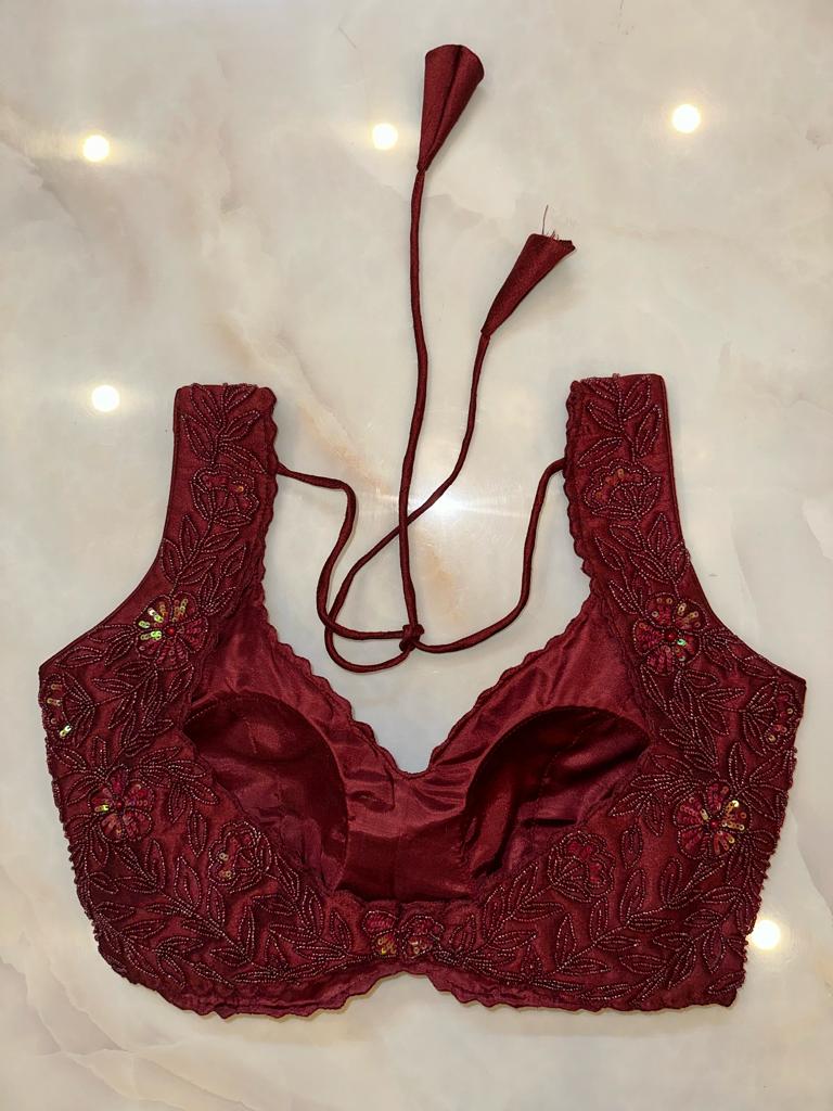 Shop maroon hand embroidered sleeveless saree blouse online in USA. Elevate your saree style with exquisite readymade sari blouses, embroidered saree blouses, Banarasi sari blouse, designer saree blouse, choli-cut blouses, corset blouses from Pure Elegance Indian fashion store in USA.-back