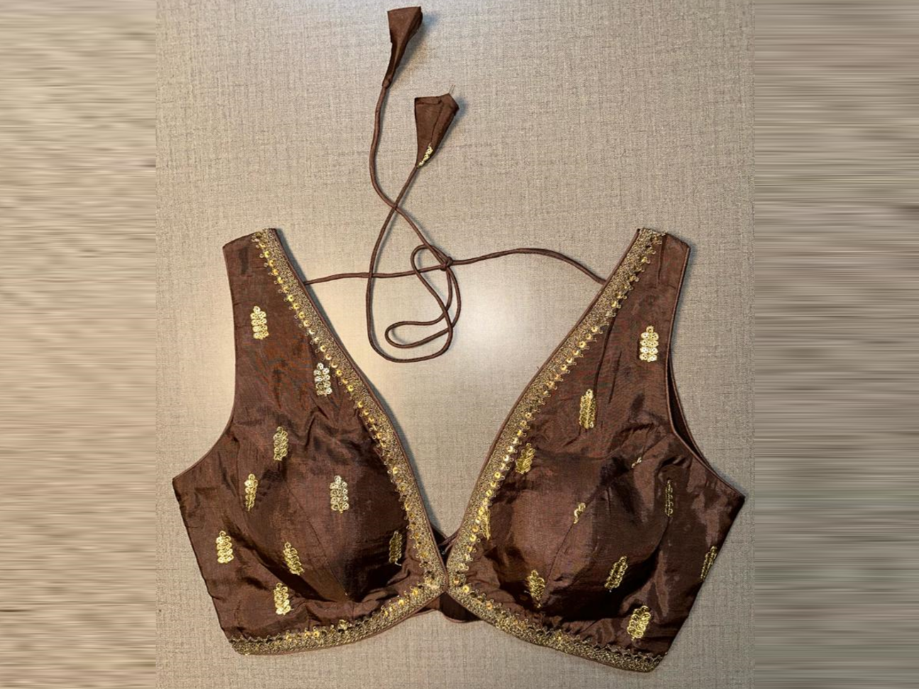 Buy brown sleeveless saree blouse online in USA with golden embroidery. Elevate your saree style with exquisite readymade sari blouses, embroidered saree blouses, Banarasi sari blouse, designer saree blouse, choli-cut blouses, corset blouses from Pure Elegance Indian fashion store in USA.-full view