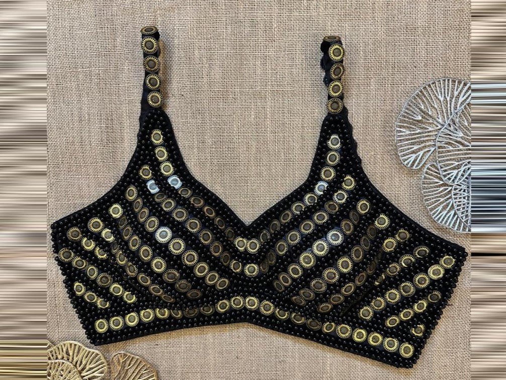 Buy black bead and golden coin designer blouse online in USA. Elevate your saree style with exquisite readymade saree blouses, embroidered saree blouses, Banarasi sari blouse, designer saree blouse, choli-cut blouses, corset blouses from Pure Elegance Indian fashion store in USA.-front