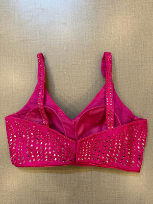 Shop stunning rani pink mirror work strappy blouse online in USA. Elevate your saree style with exquisite readymade sari blouses, embroidered saree blouses, Banarasi sari blouse, designer saree blouse, choli-cut blouses, corset blouses from Pure Elegance Indian fashion store in USA.-back