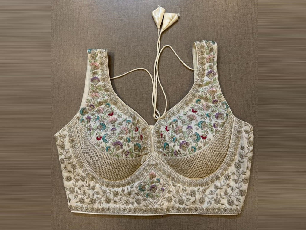 Shop white embroidered sleeveless designer saree blouse online in USA. Elevate your saree style with exquisite readymade sari blouses, embroidered saree blouses, Banarasi sari blouse, designer saree blouse, choli-cut blouses, corset blouses from Pure Elegance Indian fashion store in USA.-front