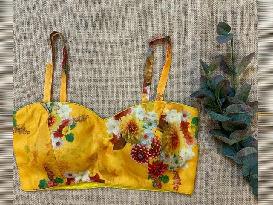 Shop stunning yellow floral spaghetti straps blouse online in USA. Elevate your saree style with exquisite readymade sari blouses, embroidered saree blouses, Banarasi sari blouse, designer saree blouse, choli-cut blouses, corset blouses from Pure Elegance Indian fashion store in USA.-front