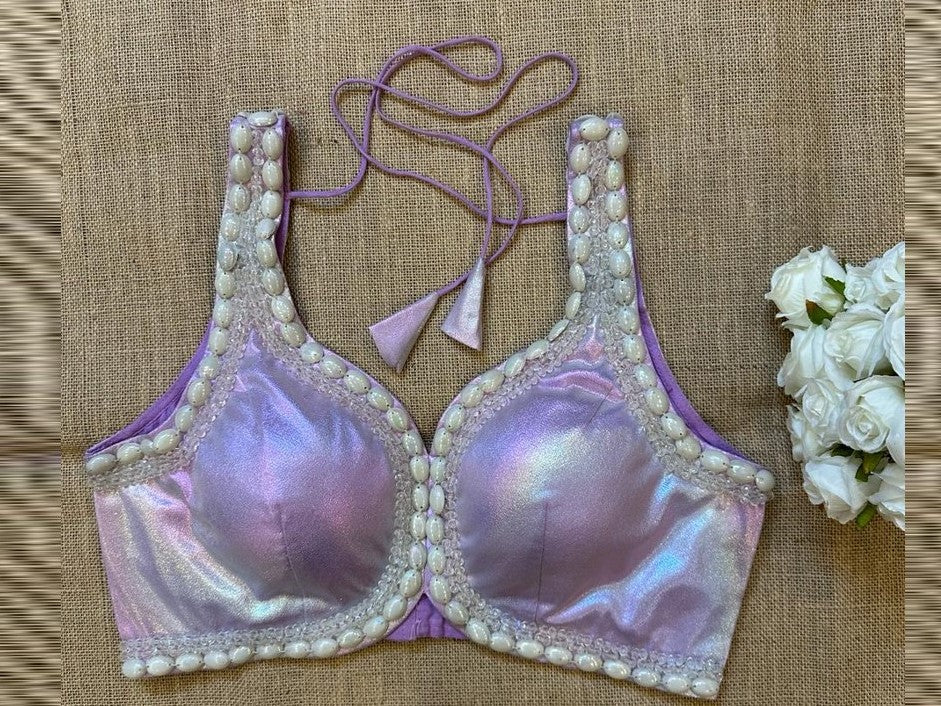 Buy lilac shimmer sleeveless blouse online in USA with bead work. Elevate your saree style with exquisite readymade sari blouses, embroidered saree blouses, Banarasi sari blouse, designer saree blouse, choli-cut blouses, corset blouses from Pure Elegance Indian fashion store in USA.-front