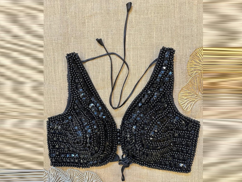 Shop black bead work designer sleeveless saree blouse online in USA. Elevate your saree style with exquisite readymade sari blouses, embroidered saree blouses, Banarasi sari blouse, designer saree blouse, choli-cut blouses, corset blouses from Pure Elegance Indian fashion store in USA.-front