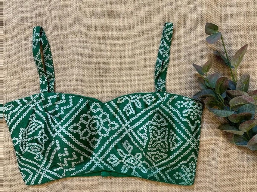 Buy stunning green strappy bandhej saree blouse online in USA. Elevate your saree style with exquisite readymade sari blouses, embroidered saree blouses, Banarasi sari blouse, designer saree blouse, choli-cut blouses, corset blouses from Pure Elegance Indian fashion store in USA.-front