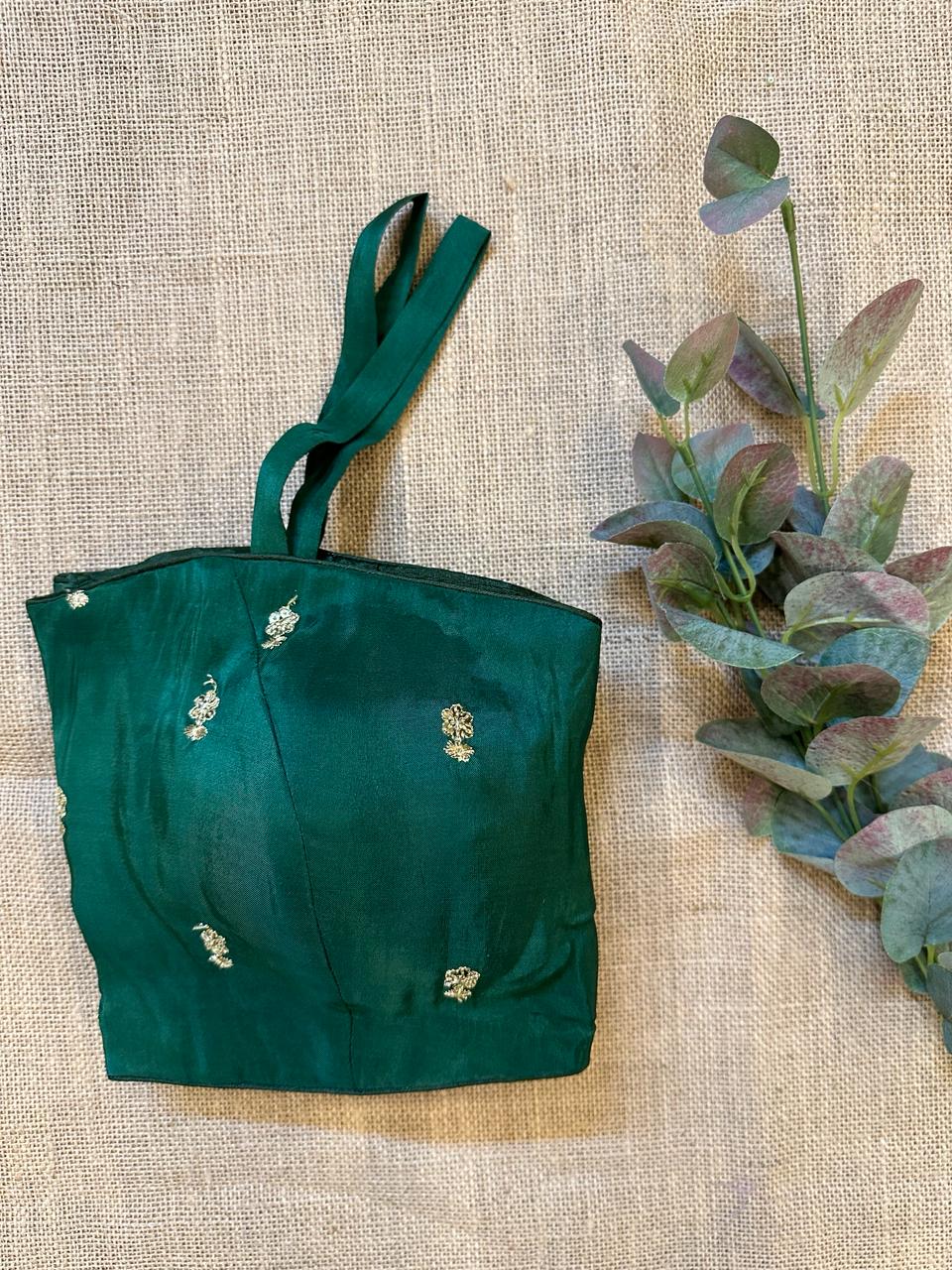 Shop dark green embroidered strappy designer blouse online in USA. Elevate your saree style with exquisite readymade saree blouses, embroidered saree blouses, Banarasi sari blouse, designer saree blouse, choli-cut blouses, corset blouses from Pure Elegance Indian fashion store in USA.-side