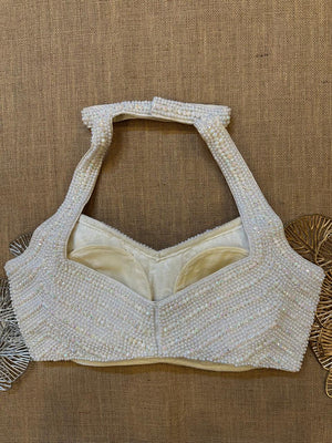 Buy stunning white bead work halter saree blouse online in USA. Elevate your saree style with exquisite readymade saree blouses, embroidered saree blouses, Banarasi saree blouse, designer sari blouse, choli-cut blouses, corset blouses from Pure Elegance Indian fashion store in USA.-back