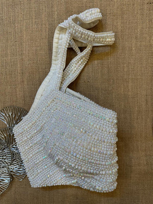 Buy stunning white bead work halter saree blouse online in USA. Elevate your saree style with exquisite readymade saree blouses, embroidered saree blouses, Banarasi saree blouse, designer sari blouse, choli-cut blouses, corset blouses from Pure Elegance Indian fashion store in USA.-side