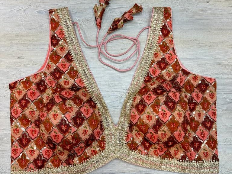 Buy orange sleeveless blouse with self-embroidery. Make a fashion statement on festive occasions and weddings with designer blouses, designer sarees, designer suits, Indian dresses, designer gowns, sharara suits, and embroidered sarees from Pure Elegance Indian fashion store in the USA.