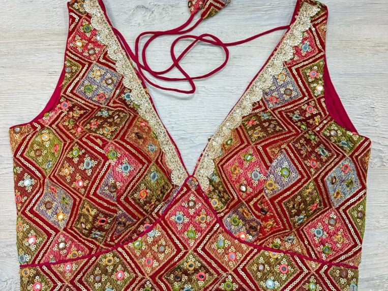 Buy maroon multicolor sleeveless blouse with thread and mirror embroidery. Make a fashion statement on festive occasions and weddings with designer blouses, designer sarees, designer suits, Indian dresses, designer gowns, sharara suits, and embroidered sarees from Pure Elegance Indian fashion store in the USA.