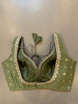 Buy green blouse with golden embroidered and dots. Make a fashion statement on festive occasions and weddings with designer blouses, designer sarees, designer suits, Indian dresses, designer gowns, sharara suits, and embroidered sarees from Pure Elegance Indian fashion store in the USA.