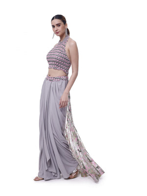 Shop beautiful grey halter neck georgette draped skirt set online in USA. Shop the best and latest designs in embroidered sarees, designer sarees, Anarkali suit, lehengas, sharara suits for weddings and special occasions from Pure Elegance Indian fashion store in USA.-set