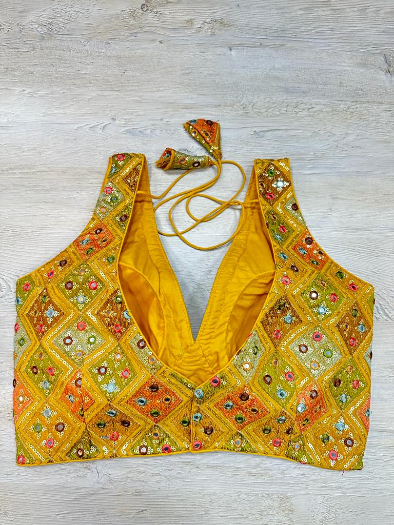 Buy yellow multicolor sleeveless blouse with thread and mirror embroidery. Make a fashion statement on festive occasions and weddings with designer blouses, designer sarees, designer suits, Indian dresses, designer gowns, sharara suits, and embroidered sarees from Pure Elegance Indian fashion store in the USA.
