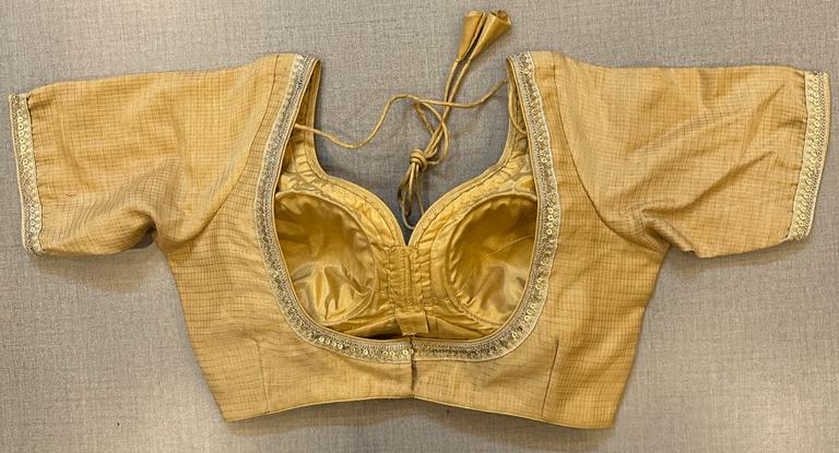 Buy beige silk blouse with embroidery on the edge, hook closure & tie-back at the back.. Make a fashion statement on festive occasions and weddings with designer blouses, designer sarees, designer suits, Indian dresses, designer gowns, sharara suits, and embroidered sarees from Pure Elegance Indian fashion store in the USA.