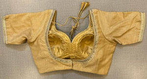 Buy beige silk blouse with embroidery on the edge, hook closure & tie-back at the back.. Make a fashion statement on festive occasions and weddings with designer blouses, designer sarees, designer suits, Indian dresses, designer gowns, sharara suits, and embroidered sarees from Pure Elegance Indian fashion store in the USA.