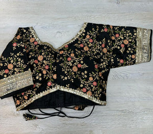 Buy black floral blouse with sequin embroidered edges and written ayushmati bhav. Make a fashion statement on festive occasions and weddings with designer blouses, designer sarees, designer suits, Indian dresses, designer gowns, sharara suits, and embroidered sarees from Pure Elegance Indian fashion store in the USA.