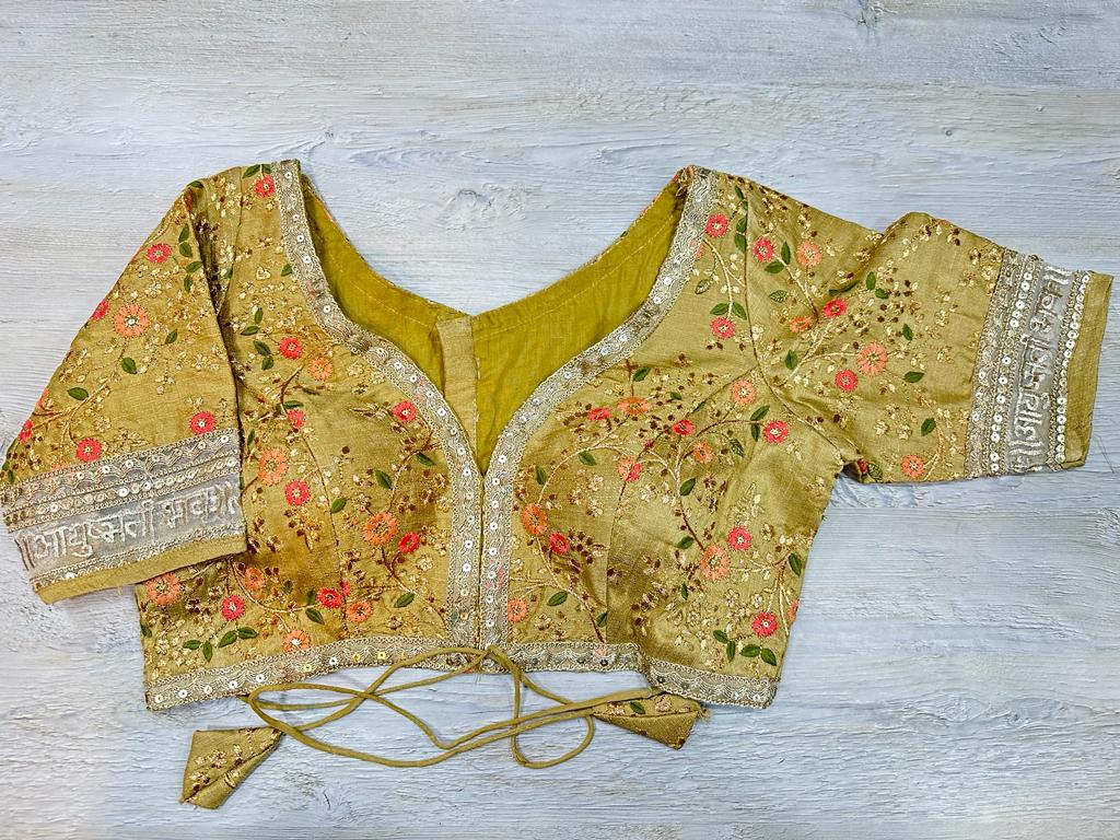 Buy mustard floral blouse with sequin embroidered edges and written ayushmati bhav. Make a fashion statement on festive occasions and weddings with designer blouses, designer sarees, designer suits, Indian dresses, designer gowns, sharara suits, and embroidered sarees from Pure Elegance Indian fashion store in the USA.