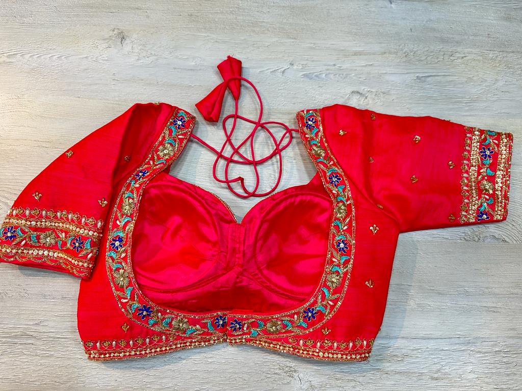Buy red embroidered blouse features cut dana and stone embroidery on the edges and stylish back. Make a fashion statement on festive occasions and weddings with designer blouses, designer sarees, designer suits, Indian dresses, designer gowns, sharara suits, and embroidered sarees from Pure Elegance Indian fashion store in the USA.